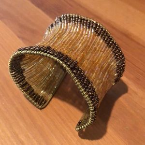 Cuff bracelet made of strands of beads.